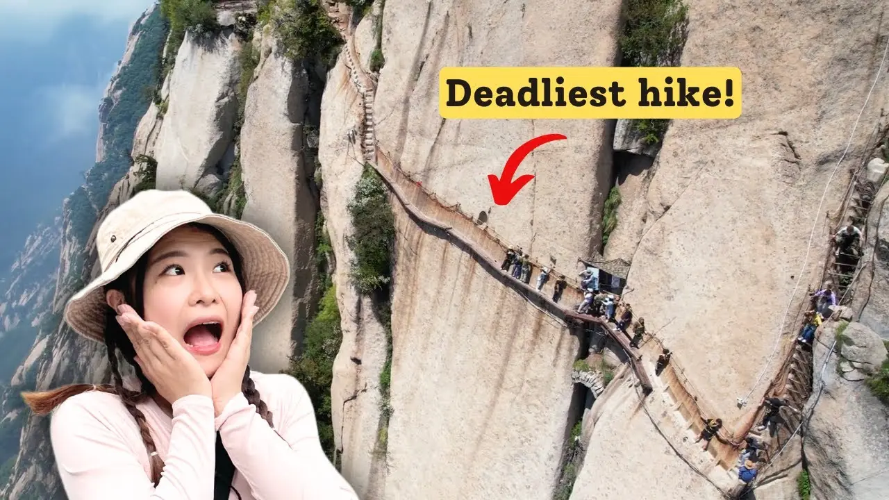 Narrow wooden planks along cliff face on Huashan Mountain's dangerous plank walk trail in China.